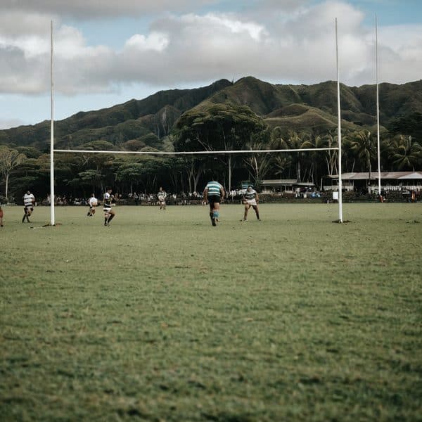 Rugby players practicing on field in Fiji.