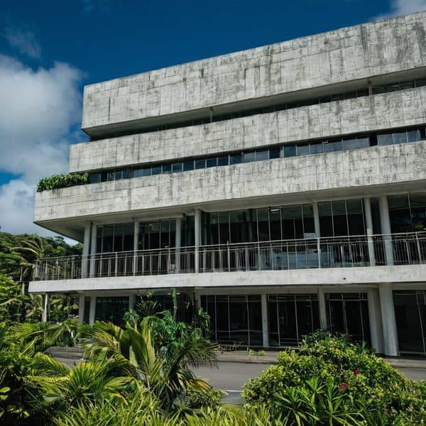 Modern concrete building with lush greenery in Fiji.