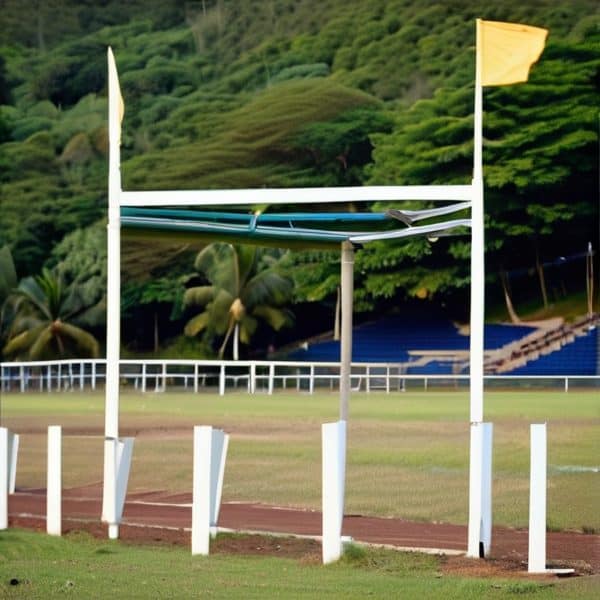 Goalposts on a sports field in Fiji, surrounded by lush greenery and tropical trees.