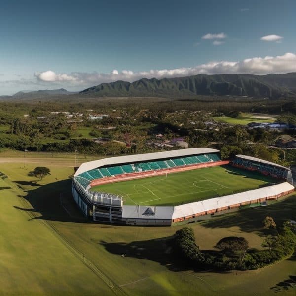 Fiji sports stadium surrounded by lush greenery and mountains in the background.