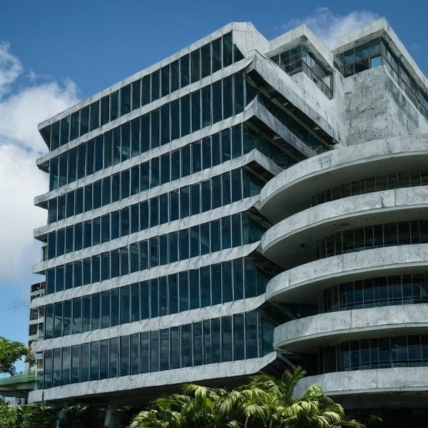 Modern office building with glass facade in Fiji, showcasing contemporary architecture.